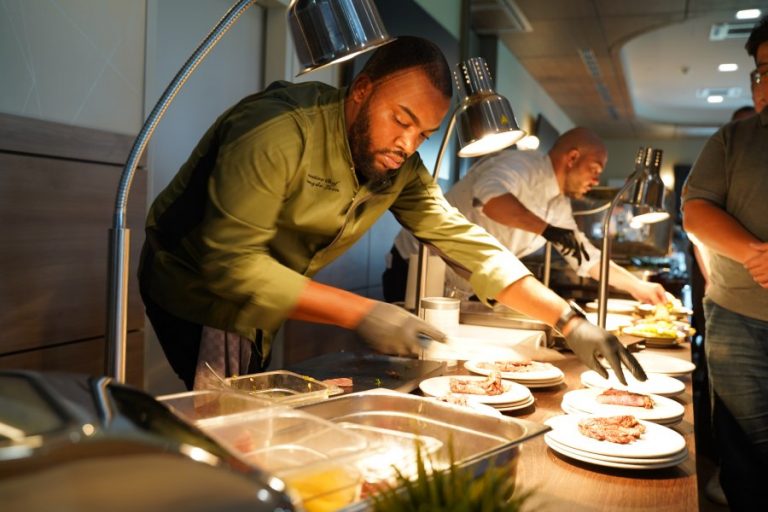 Privatkoch & Sportkoch für Profisportler in NRW - Quency von Essence Meals. Er richtet Essen für ein privates Catering an.